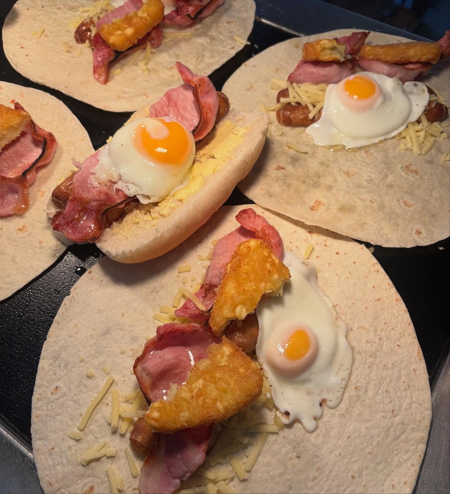 Breakfast wraps with bacon, hash brown and fried egg, and a bacon and egg roll at The Oven Door Cafe, Haydock